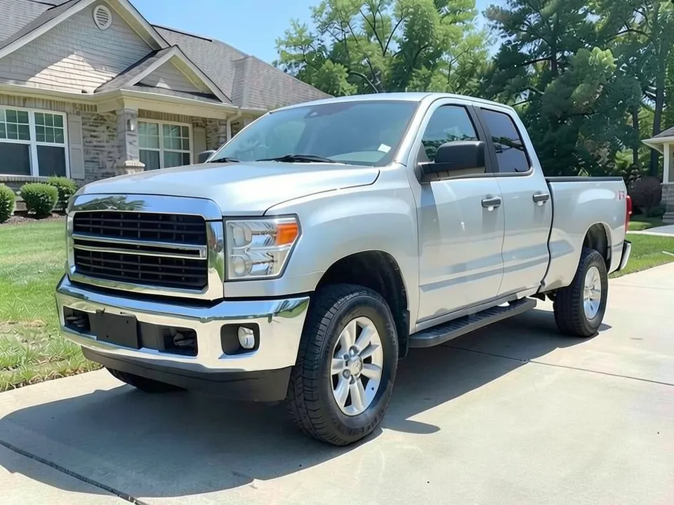 AI-drawn sample: a silver generic full-size pickup stand-in, crew cab, on silver wheels parked on a concrete driveway in front of a house