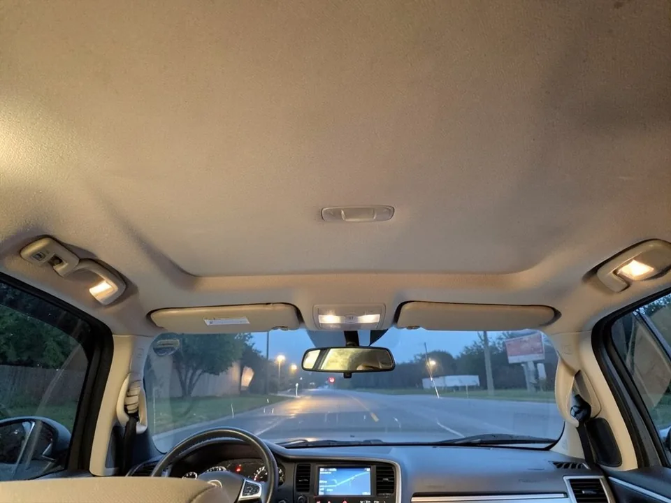 AI-drawn sample: the beige fabric roof lining of a pickup truck cab seen from the passenger seat in the evening