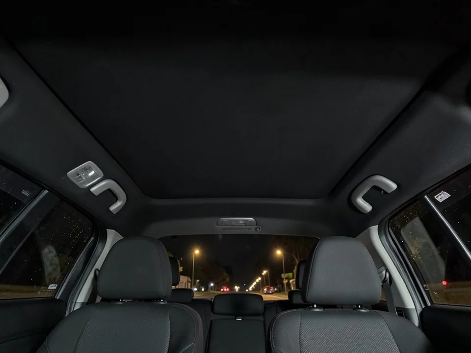 AI-drawn sample: the black fabric roof lining of a sedan seen from the rear seat at night