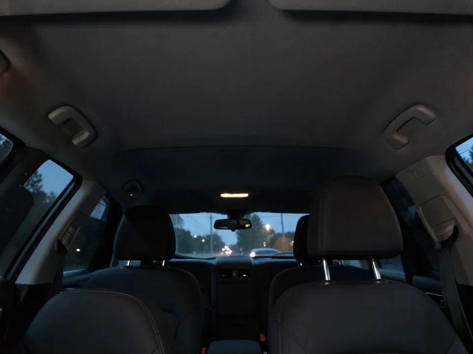AI-drawn sample: the dark gray fabric roof lining of an SUV seen from the back seat at dusk